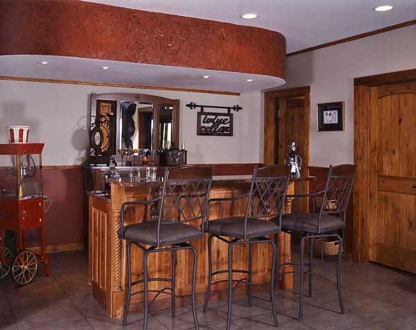 The friends' favored mix of wrought iron and wood is showcased beautifully in the built-in basement bar. "The combination brings a level of authenticity to the older look, but still keeps it modern," explains Marshall. A 20-foot iron stair railing, made by a local blacksmith, and iron balusters interspersed on the deck railing continue the theme.