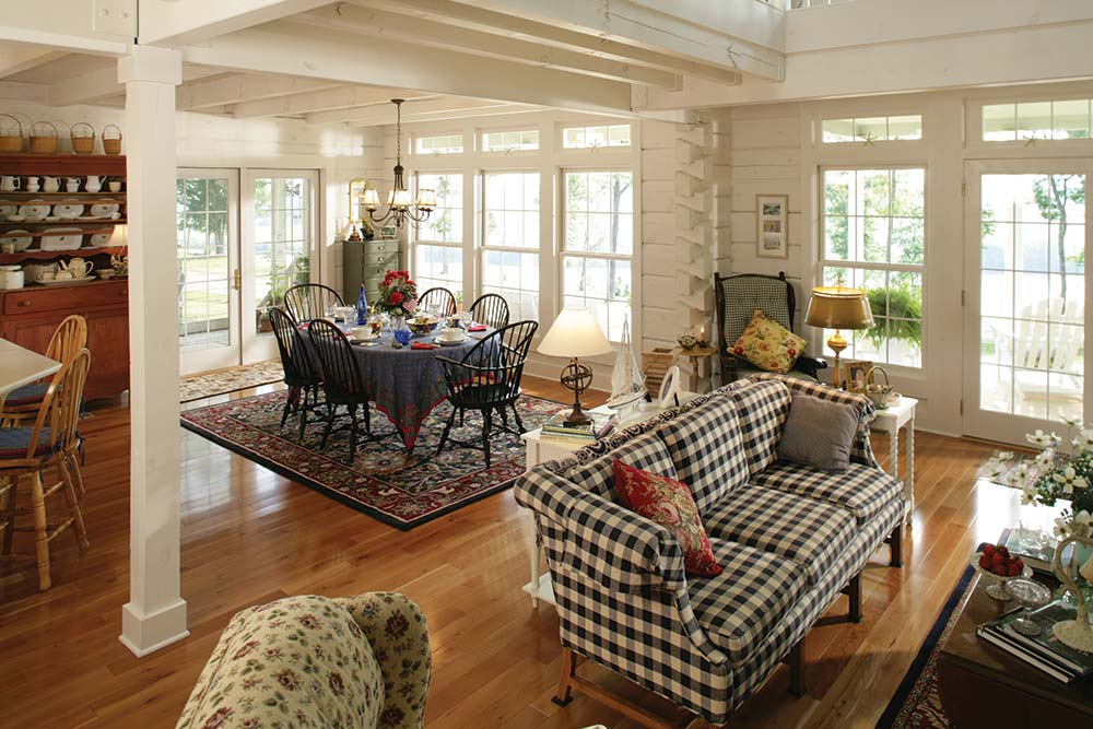 Whitewashed logs and window trim can create a contemporary mood that’s unexpected in a log home. This scheme downplays the logs, allowing a more subdued dining set. White walls also reflect light throughout the space.