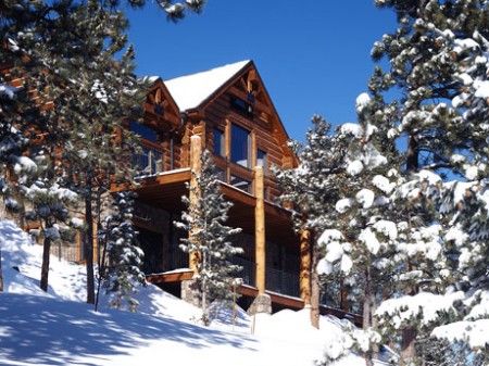 Rear view of snow covered cabin.