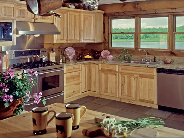 Contemporary conveniences paired with rugged elements prove to be a tasteful combination in this airy space. A maple butcherblock counter top is both distinctive and functional. The stainless steel appliances lend a modern sparkle to on an otherwise rustic room.
